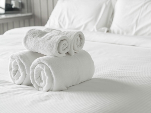 respite care image with towels rolled up on bed