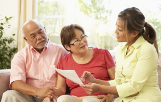 elder couple talking about money and retirement with advisor