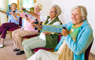 Heritage Woods Senior Women Sitting In Chairs Exercising