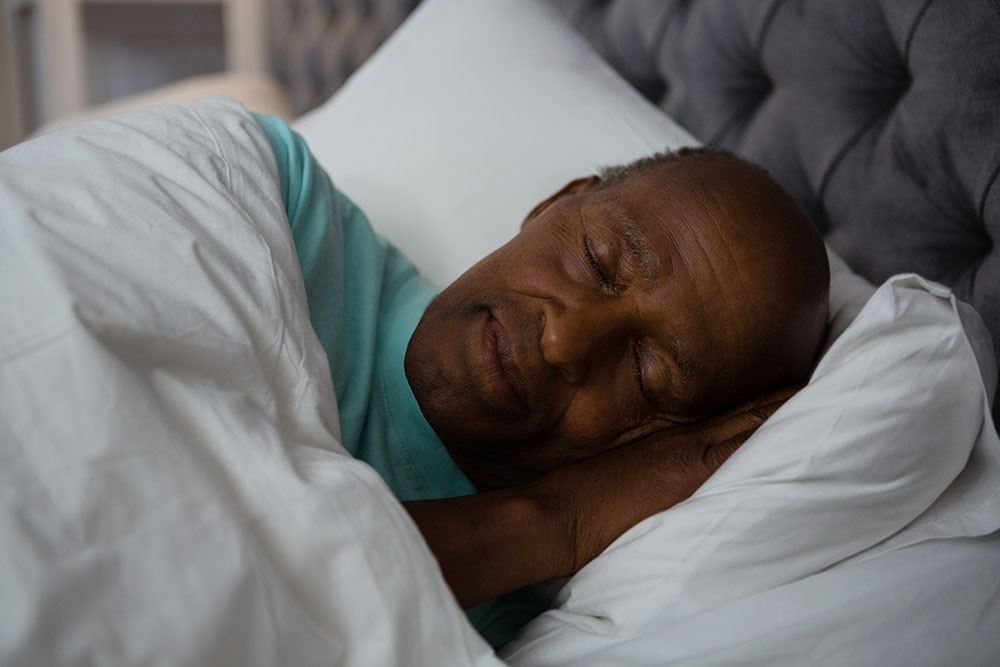 Senior man sleeping in bed