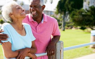 Senior couple laughing outside independent living community
